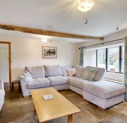 A living room with sofas coffee table window and floor lamp at The Birches in Hay-on-Wye