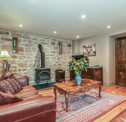 A living room with a sofa and a coffee table at The Lodge Farm Barn Deepdean near Ross-on-Wye