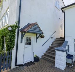 A stairway leading up to a door with a planter at Severn Bank Lodge in Astley Burf near Stourport-on-Severn
