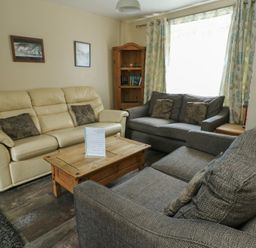 A living room with a sofa and coffee table at Halford Hill in Llanberis