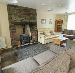 A living room with a fireplace and sofas at Halford Hill Llanberis
