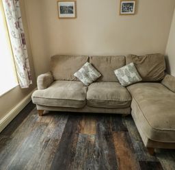 A living room with a sofa and cushions at Halford Hill in Llanberis