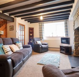 A living room with sofas and a TV at Bryn Re Trawsfynydd near Llan Ffestiniog and Dolgellau