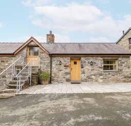 A stone house with steps and wooden door at Briws and 963354 together they sleep 35