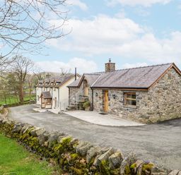 A house with a stone exterior and a driveway at Briws and 963354 together they sleep 35