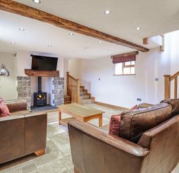 A living room with a fireplace and television at Briws and 963354 together they sleep 35