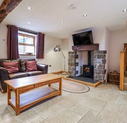 A living room with a sofa and coffee table at Briws and 963354 together they sleep 35