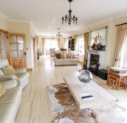 A living room with sofas coffee table fireplace and dining table at Shraigh Beach in Belmullet County Mayo