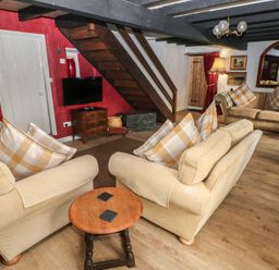 A living room with sofas and a television at Maesgwyn in Bridell near Cardigan