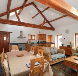 A kitchen with wooden furniture and appliances at Riverside Barn Gilwern near Crickhowell and Abergavenny