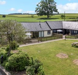A building with garden and outdoor seating at The Old Cart Shed Winterborne Stickland