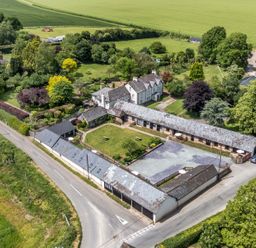 An outdoor area with house, gardens, and barn at Rowdens Barn in Winterborne Stickland