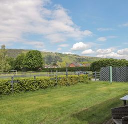 An outdoor view with grass and trees at Longside in Gilwern