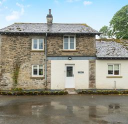 A cottage with stone walls and a front door at Jubilee at the Graythwaite Estate near Hawkshead