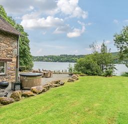 An outdoor space with a house by the lake at Hammerhole at the Graythwaite Estate near Hawkshead