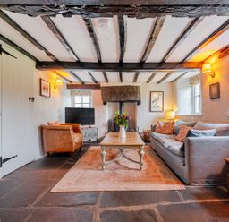 A living room with a sofa and coffee table at Hullet Hall at the Graythwaite Estate near Hawkshead