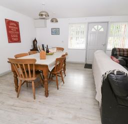 A dining room with a table and chairs at Cariad Cottage in Cross Inn