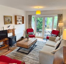 A living room with a coffee table and television at 38 Dale End Brancaster Staithe near Burnham Market