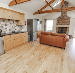 A kitchen with appliances and seating area at Grey Croft in Embleton