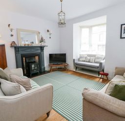 A living room with sofas and a television at Rose Cottage St Dogmaels near Cardigan