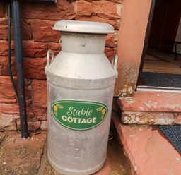 A milk can next to steps at Stable Cottage in Bolton Low Houses