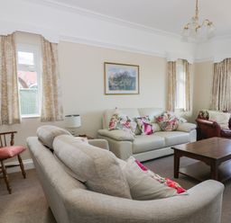 A living room with sofas wooden chair and coffee table at Seascape in Bridlington