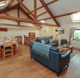 A living room with a dining area and seating at Hayloft Cottage Bolton Low Houses