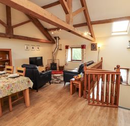 A living room with dining area at Horseshoe Cottage in Bolton Low Houses