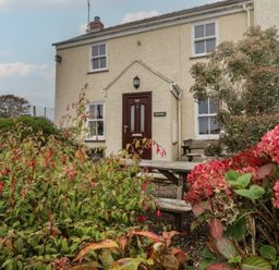 A house with a front door and garden at Garth Cottage in Haverfordwest