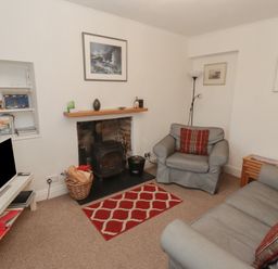 A living room with a sofa and armchair at Garth Cottage in Haverfordwest