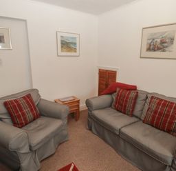 A sitting room with two sofas and a table at Garth Cottage in Haverfordwest