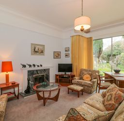 A living room with armchairs sofa coffee table and lamps at West Ridge in Boscombe