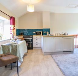 A kitchen with a dining table set at Peniarth in Penybontfawr near Oswestry