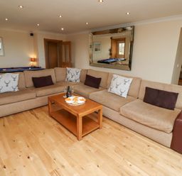 A living room with a sofa and coffee table at Granary Stone House in Embleton