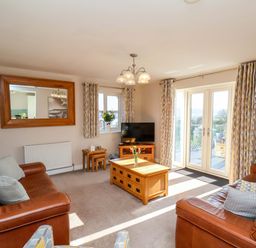 A living room with a television and seating at Heather Croft in Robin Hood's Bay