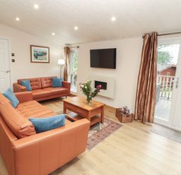 A living room with sofas and a television at Beech Hill Lodge (Beech Hill 9) at Fallbarrow Park, Bowness-on-Windermere