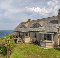 A house with a garden and deck overlooking the sea at Cragford Sennen Cove
