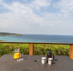 A table with drinks overlooking the sea at Cragford Sennen Cove