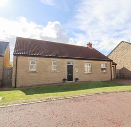 A house with a garden and pathway at The Haven in Embleton