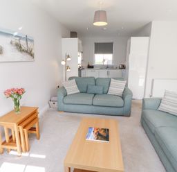 A living room with sofas and a table at The Haven in Embleton