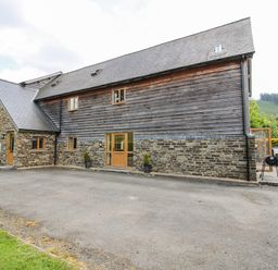 A house with windows and a driveway at The Hayloft in Bleddfa near Knighton
