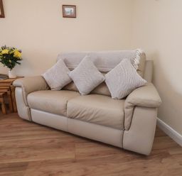 A sofa with cushions and a coffee table in a living room at La Rochelle in Whitby