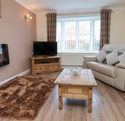 A living room with a sofa and coffee table at La Rochelle in Whitby