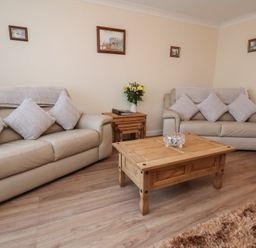 A living room with sofas and a coffee table at La Rochelle in Whitby