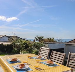 A table set with food and drinks in the garden at Highdown in Bigbury on Sea near Modbury