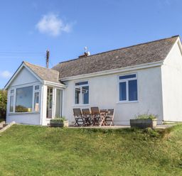 A house with a terrace and furniture at Highdown in Bigbury on Sea near Modbury