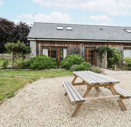 An outdoor table and bench near a house at Budmouth in Upwey near Weymouth