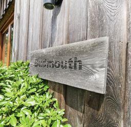 A sign reading Budmouth on a wooden wall at Budmouth Upwey near Weymouth