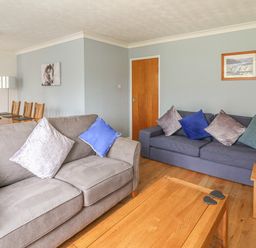 A living room with two sofas and a wooden coffee table at Trederwen in Rhayader