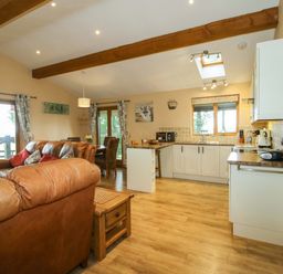 A kitchen with a sofa and coffee table at Valley View Lodge Welshpool